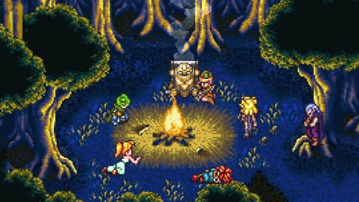 The whole party sitting around a campfire in the forest at night